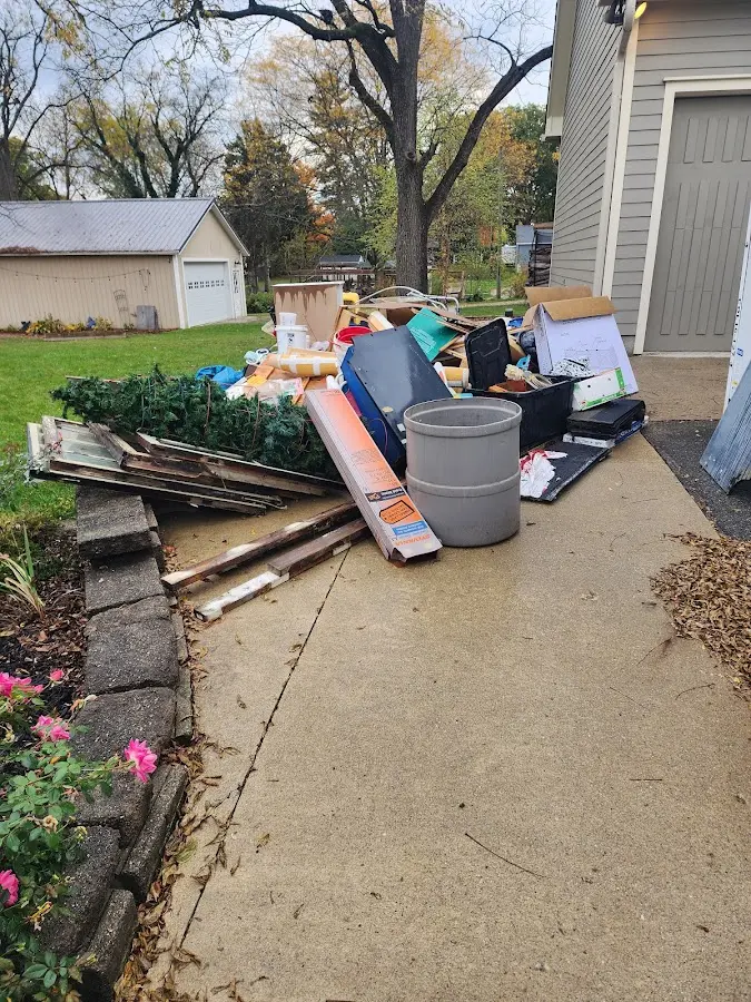 Dumpster being loaded with debris for Residential Dumpster Rental in River Road